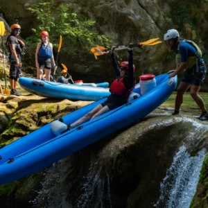 Vodič gura gosta niz slap u kajaku na rijeci Mrežnici