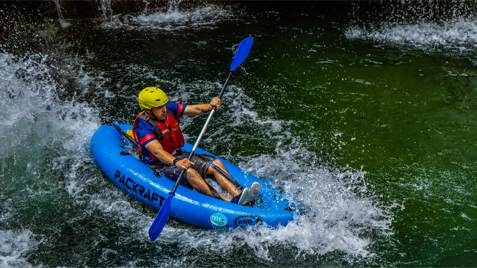 A person in a packraft going down a watefall on Mreznica river
