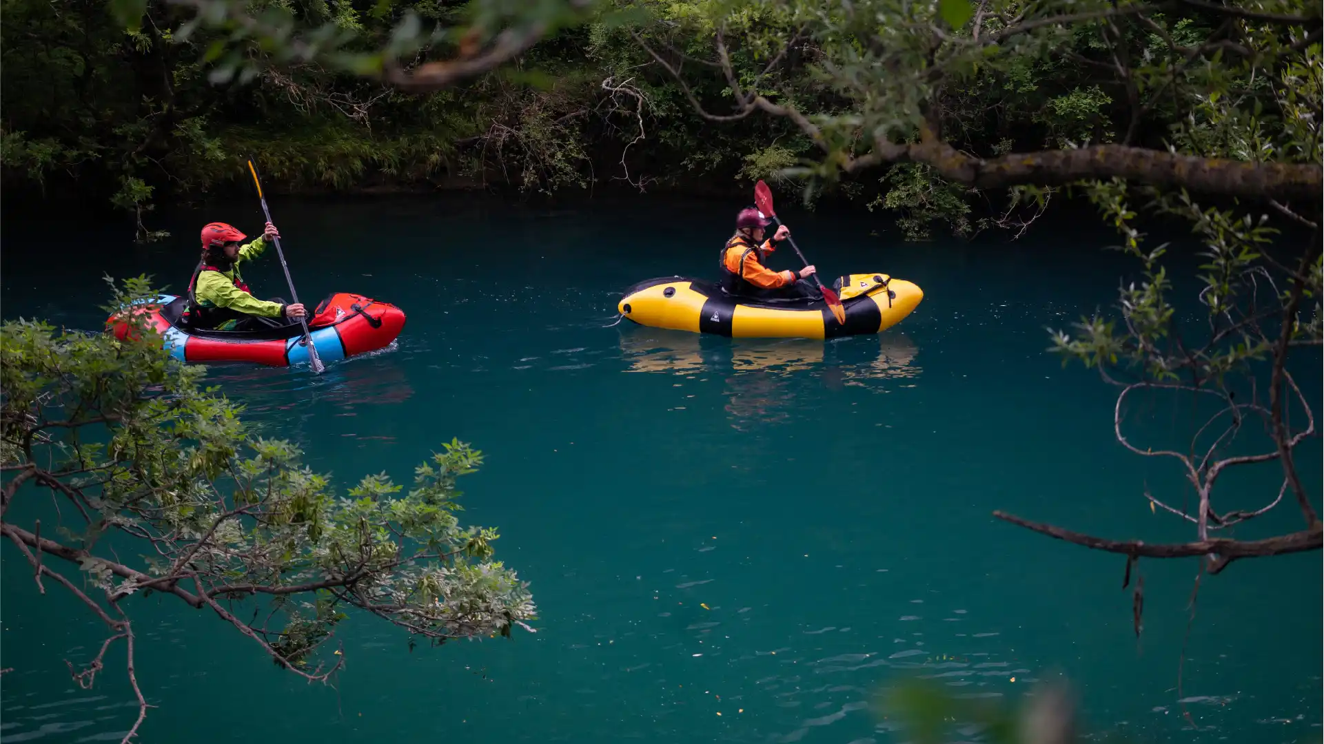 Two people packrafting down Mreznica river