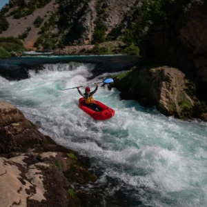 A person in a packraft, going down a rapid on Zrmanja River
