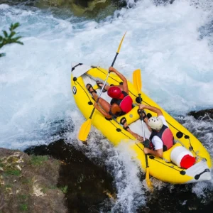 Birds view of 2 people going down a rapid in a kayak