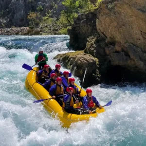 A group of people in a raft going through a rapid on Zrmanja river