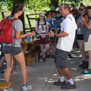 Group of people dancing on the terrace of the mountain hut