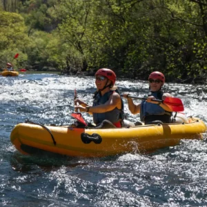 Two guests paddling in a kayak down Zrmanja River
