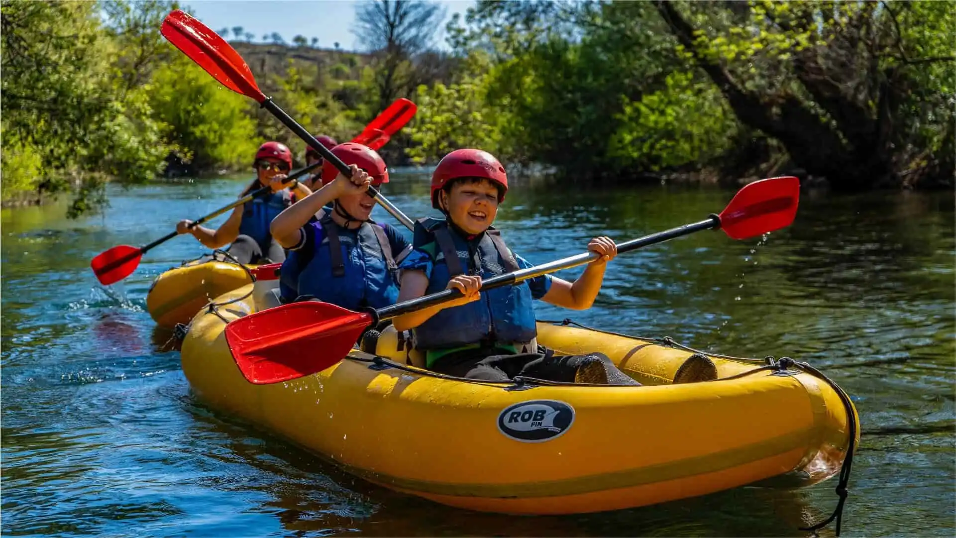 Two kids together in a kayak, paddling down Zrmanja River and having fun
