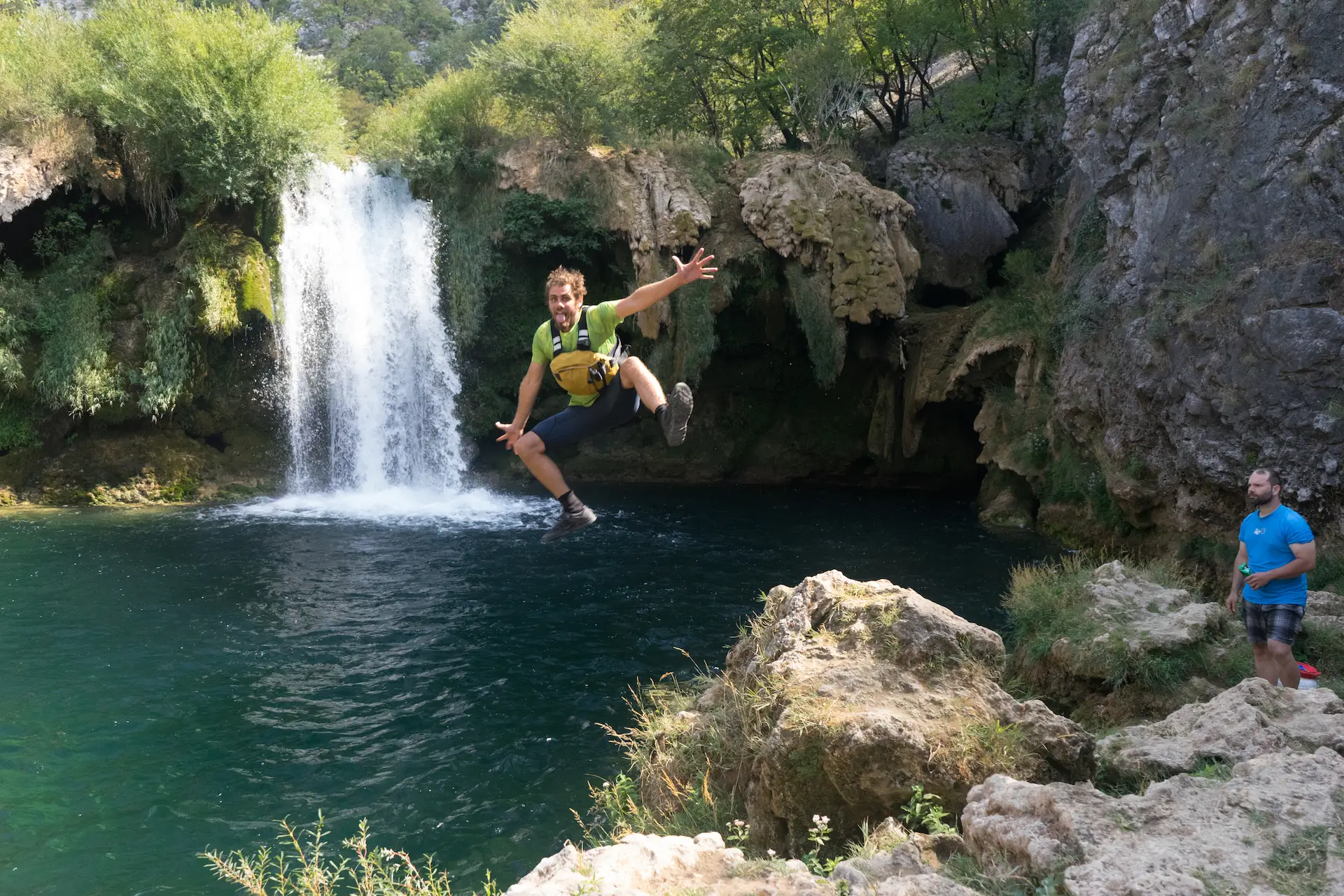 Person Jumping on the hidden Krupa waterfall